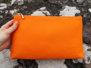 Close up view of tangerine cosmetic bag