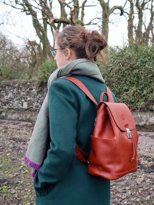 Leather drawstring duffle backpack, handmade in Ireland. Available in Chestnut, Black, Dark brown, Burgundy, Navy and Red. Side view